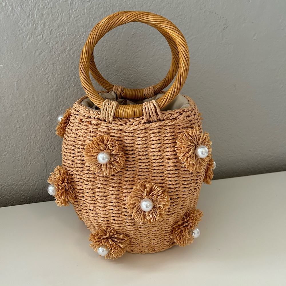 Woven pearl top handle purse